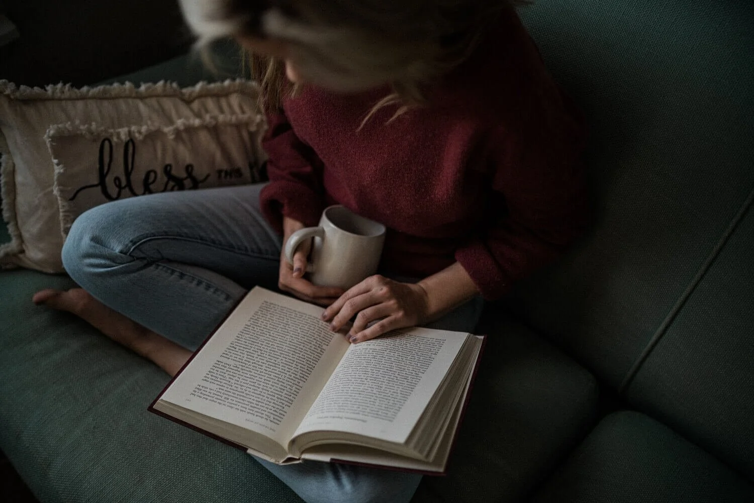 Reading a book with a cup of tea or coffee